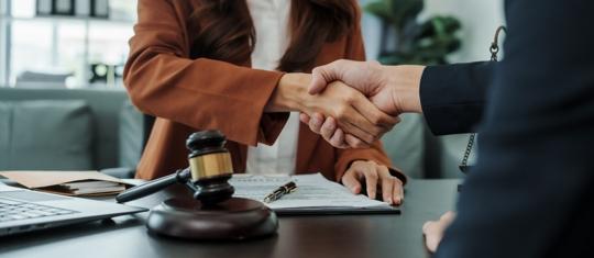lawyer shaking hands with client