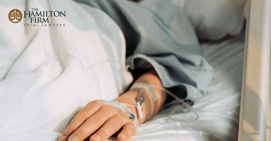 Hand in hospital bed